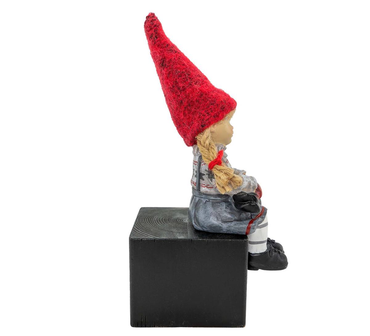 Girl sitting and holding skis, red hat